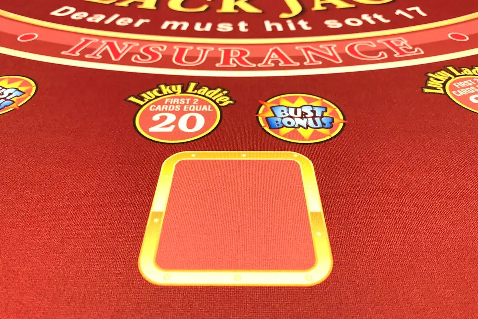Red blackjack table felt showing the insurance line and betting circle