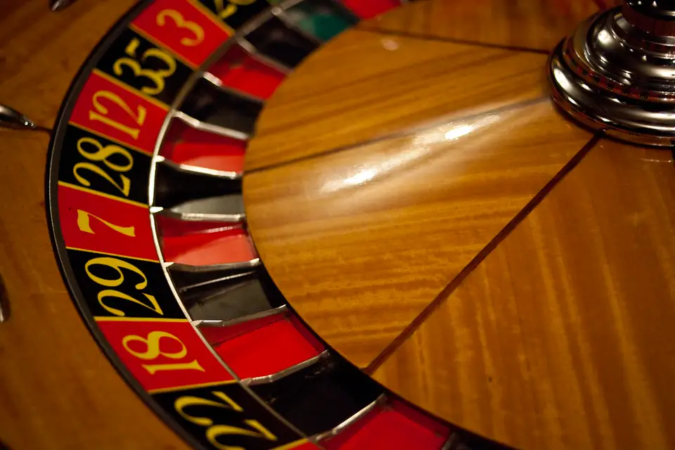 Close-up of a red and black roulette wheel with numbered pockets